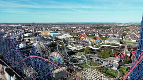 aerial drone flight around blackpool pleasure beach showing a detailed view inside the themepark and the rollercoaster rides