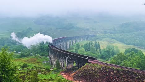 steam train at glenfinnan viaduct, railway viaduct in lochaber, scotland. - wide shot