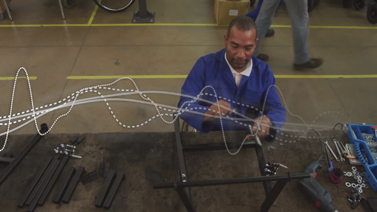 technician using tools assembling metal frames in factory, with animated data flow overlays