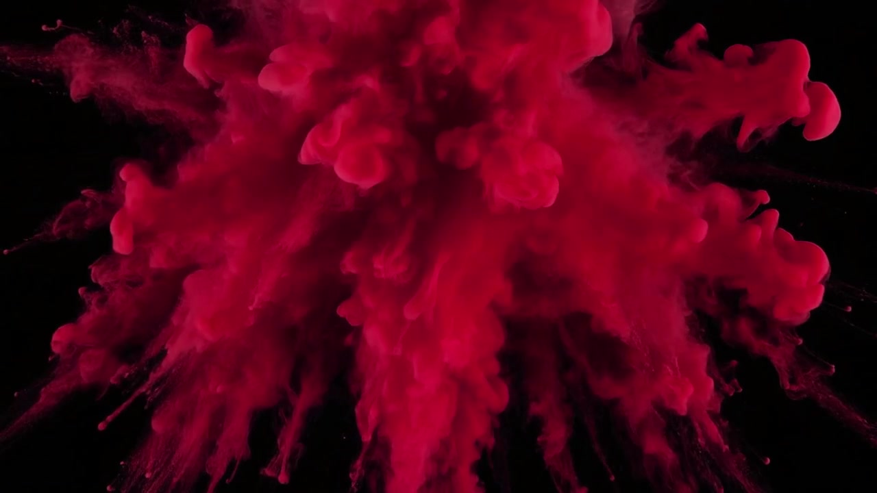 Vibrant Red Powder Explosion Against Black Background