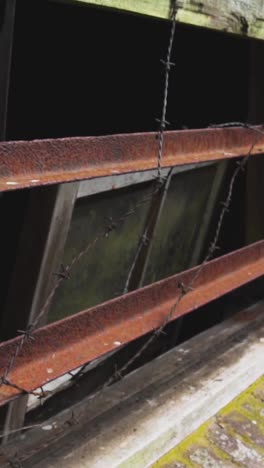 rusty window with barbed wire