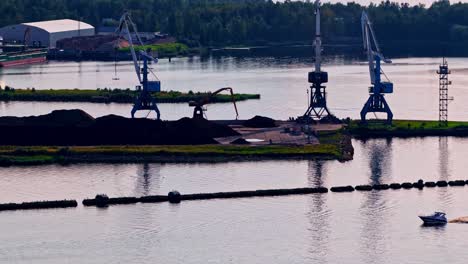industrial cranes by the river loading cargo under a clear sky