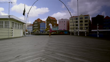 tourist over opening queen emma bridge. willemstad, curaçao. tourism in sint anna bay. travel time lapse
