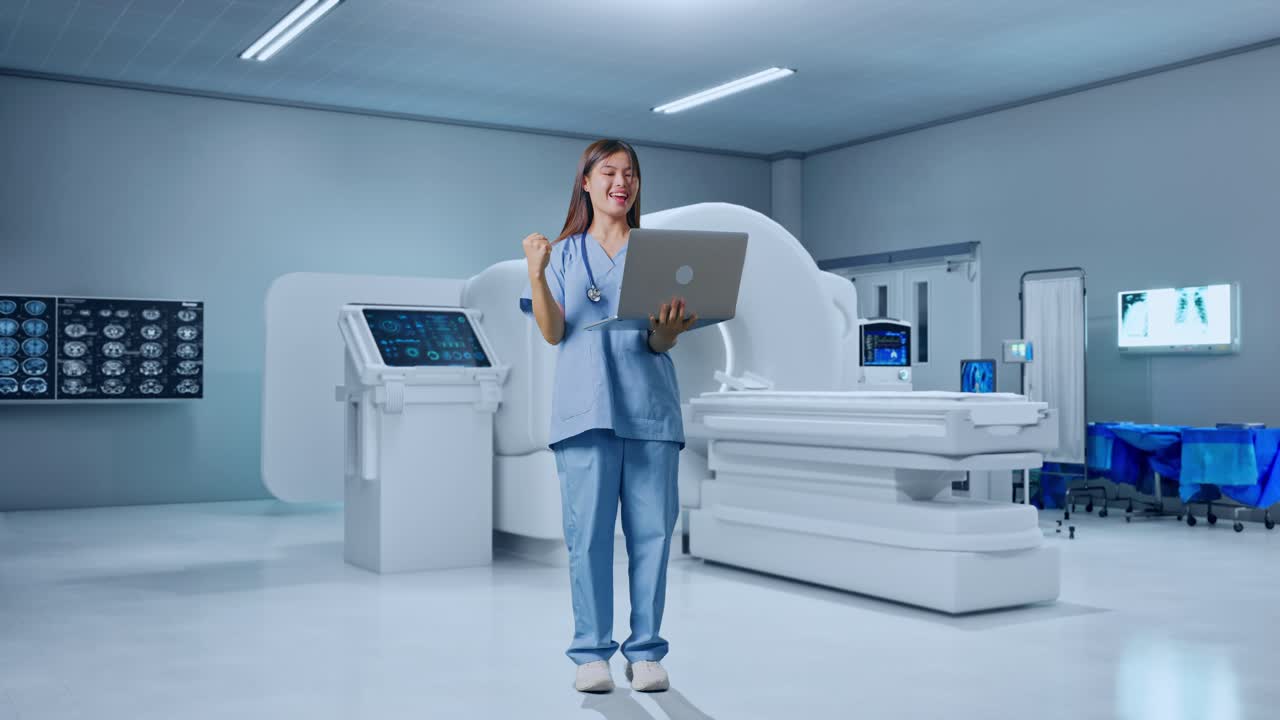Full Body Of Asian Female Doctor Looking At A Laptop And Celebrating The Succeed With Mri Machine