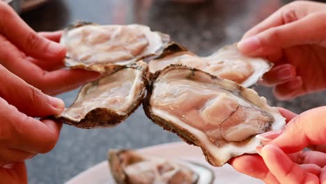 hands carefully handling fresh oysters in chonburi