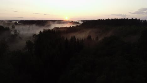 Flight-above-sunset-fog-in-golden-hour-after-rain