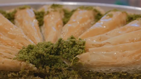 havuch baklava turkish dessert. dolly shooting hawuch. in a large plate, baklava khavuch stuffed with pistachios. turkish confectionery. 4k video