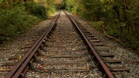 Slow-tilt-down-shot-of-disused-railway-tracks-on-anglesey,-North-Wales-4k-resolution