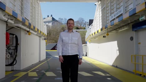 Smiling-captain-approach-and-pose-in-front-of-camera-at-ferry-car-deck