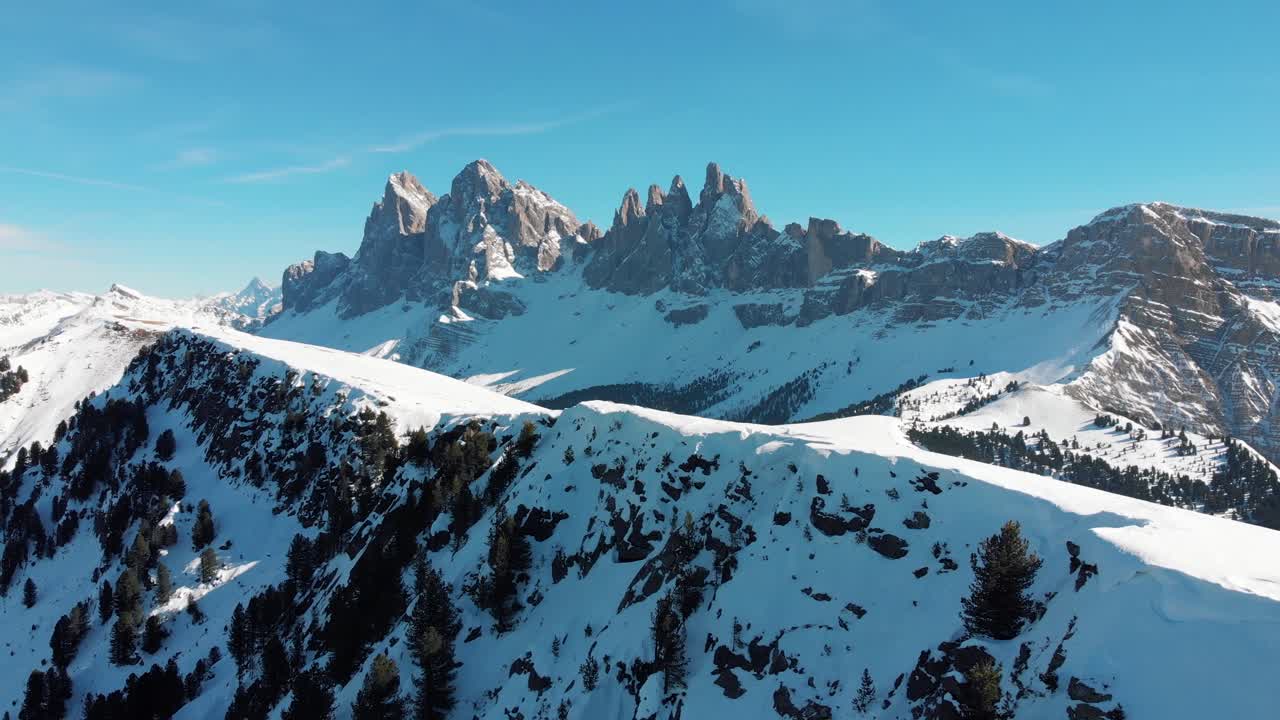 Aerial drone shot of Odle-Dolomites, slowly turning around revealing the panorma of Seiser Alm, Langkofer and Rosengarten in winter, South Tyrol, Italy