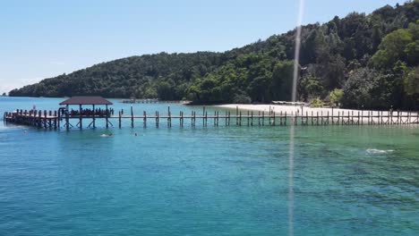 Aerial-View-Of-Pier-From-Manukan-Island-Beach