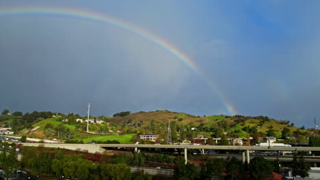 drone shot of a rainbow over walnut creek, california midday