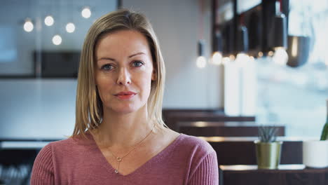 Head-And-Shoulders-Portrait-Of-Serious-Mature-Businesswoman--Working-In-Modern-Office