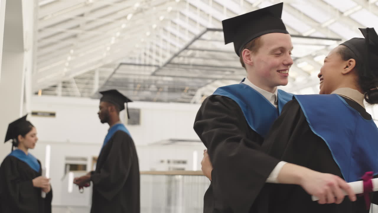 Happy Diverse Friends Hugging during Graduation