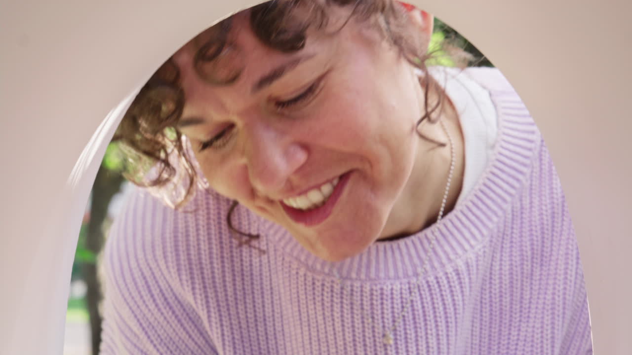 Smiling Woman Removing Envelopes from Outdoor Mailbox on Sunny Day