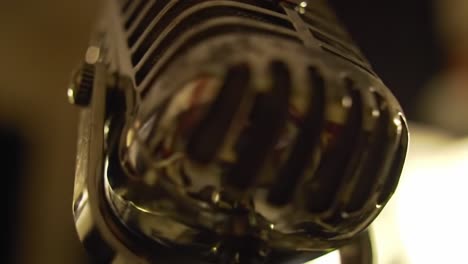 a glimmering vintage microphone captured in two frames, showcasing its unique design and reflective surface in stunning detail and artistic lighting conditions