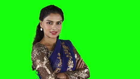 indian woman smiling at the camera with folded hands