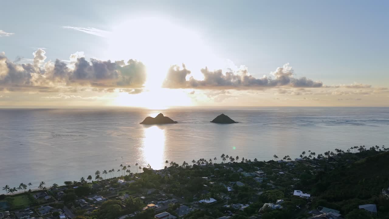 Sunrise over Mokulua Islands and Lanikai town on Oahu, Hawaii, aerial