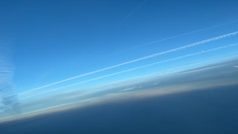 aerial view of some jet wakes taken from a cockpit in a right turn, over the sea
