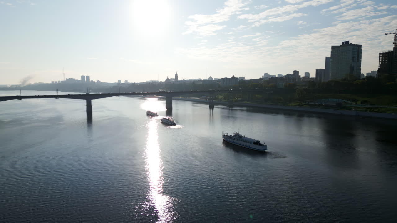 River View with Bridge and Boats Against a Bright City Skyline