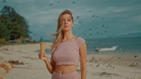 woman enjoying ice cream on a beach