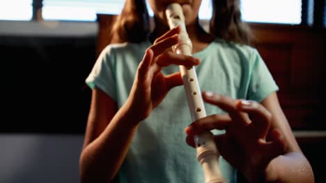 schoolgirl playing flute in music class 4k