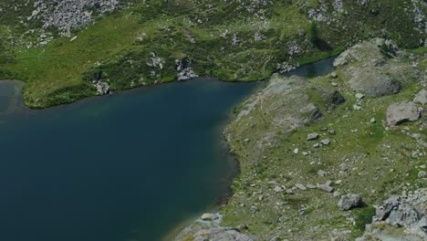 Water-surface-of-mountain-lake-in-summer-season-in-Valmalenco-of-Valtellina-in-northern-Italy