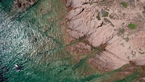 aerial shot from above of rocky coastline in sardinia island italy