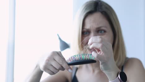 Woman discovers significant hair loss on her brush and reacts with distress