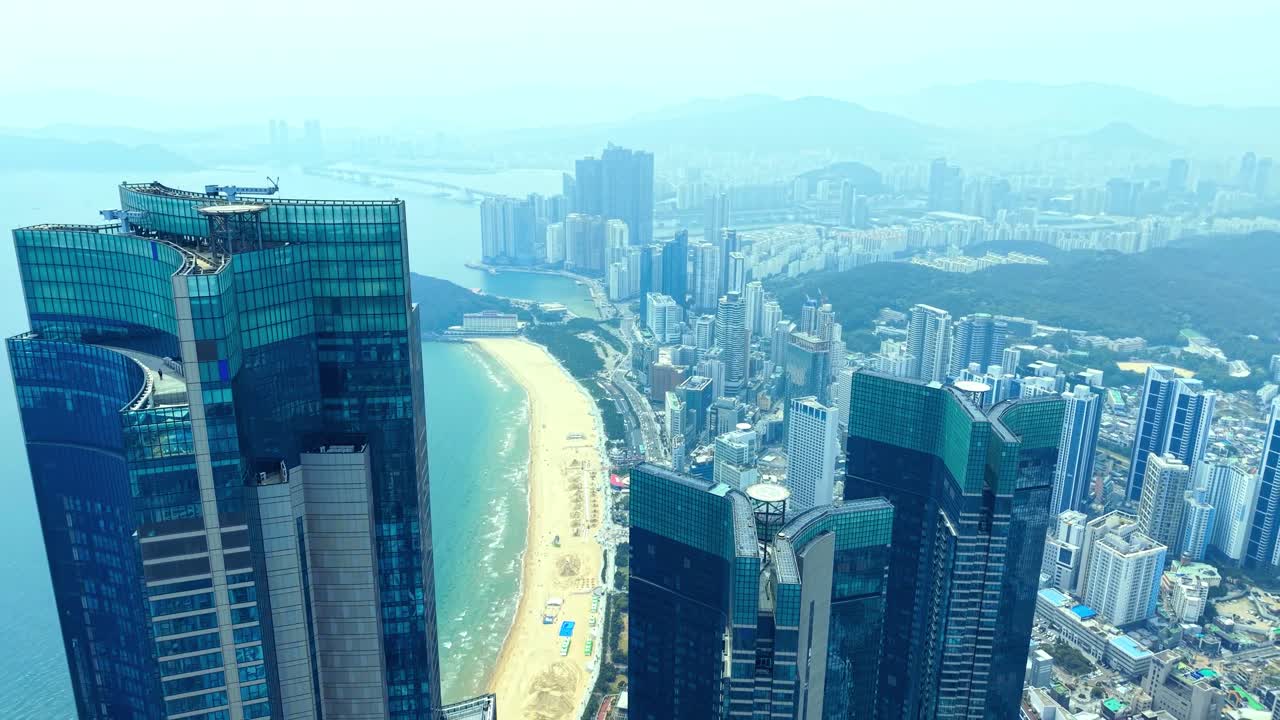 Aerial over Haeundae Beach, Marine City skyline, Busan