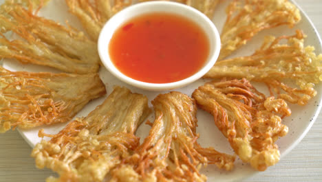 deep fried enoki mushroom or golden needle mushroom with spicy dipping sauce - vegan food style