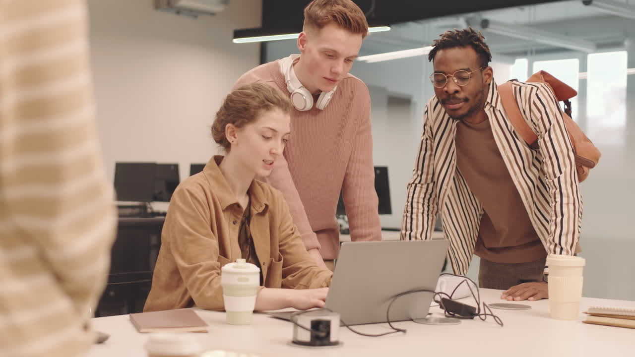 Multiethnic IT Students Working on Laptop in Class