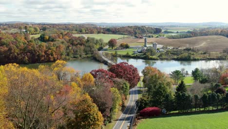 aerial establishing shot of road and bridge over lake in lancaster county, pa usa