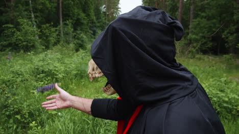 Close-Up-Of-Black-Reaper-With-Smoky-Animal-Skull-Smell-Lupine-Flower-And-Throw-Away