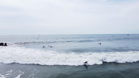 Panning-view-of-a-a-girl-taking-a-video-of-surfer-with-dreadlocks