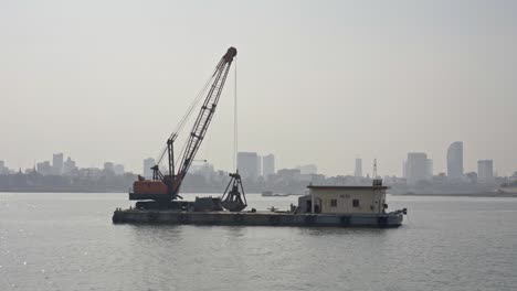 Backhoe-on-a-floating-platform,-Mekong-River