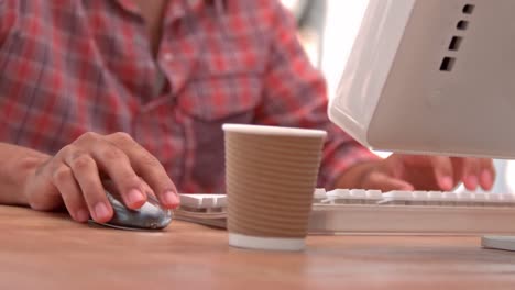 casual businessman typing on his computer