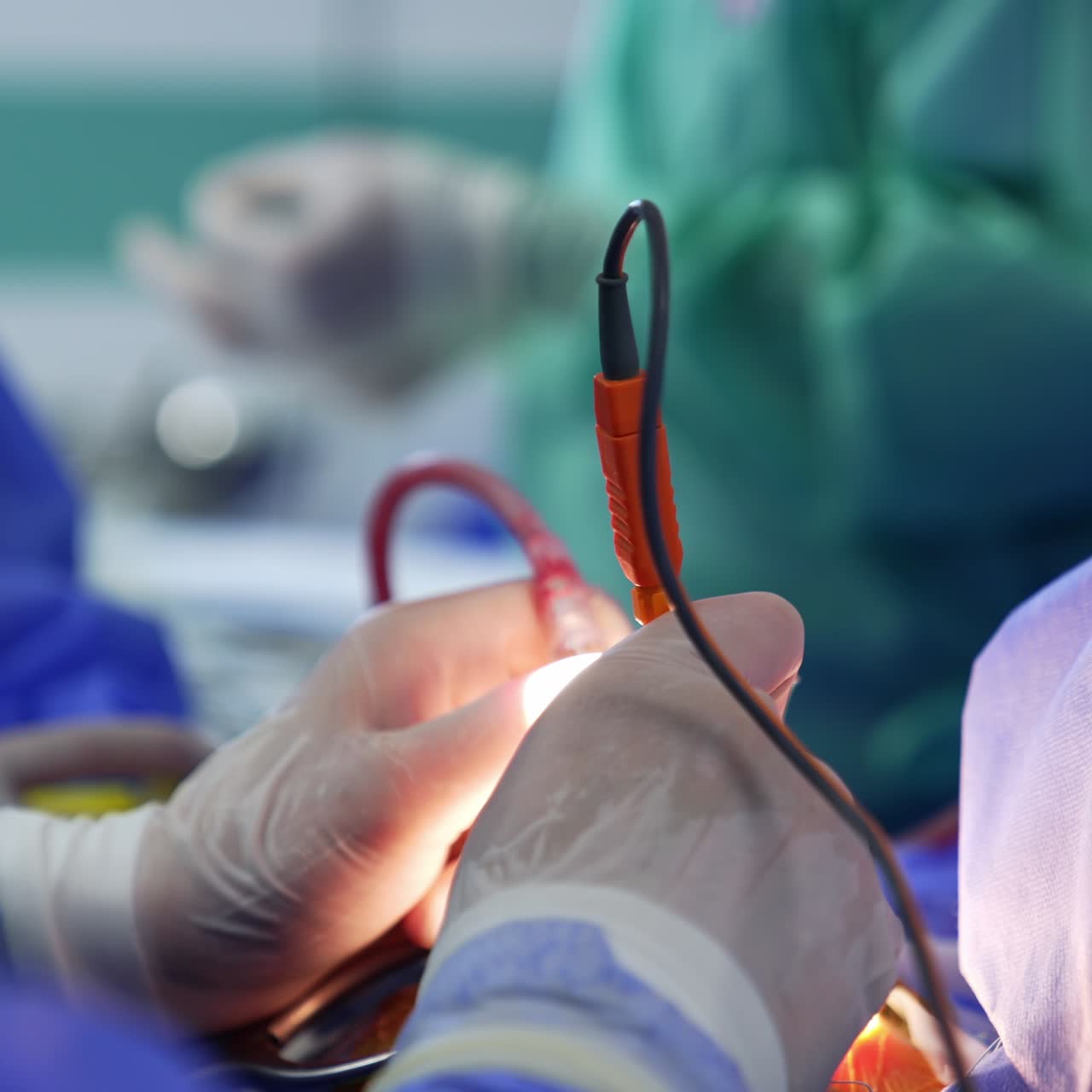 Gloved hands using the device instruments. Doctor holding tools in both hands performing surgery. Close up. Blurred backdrop