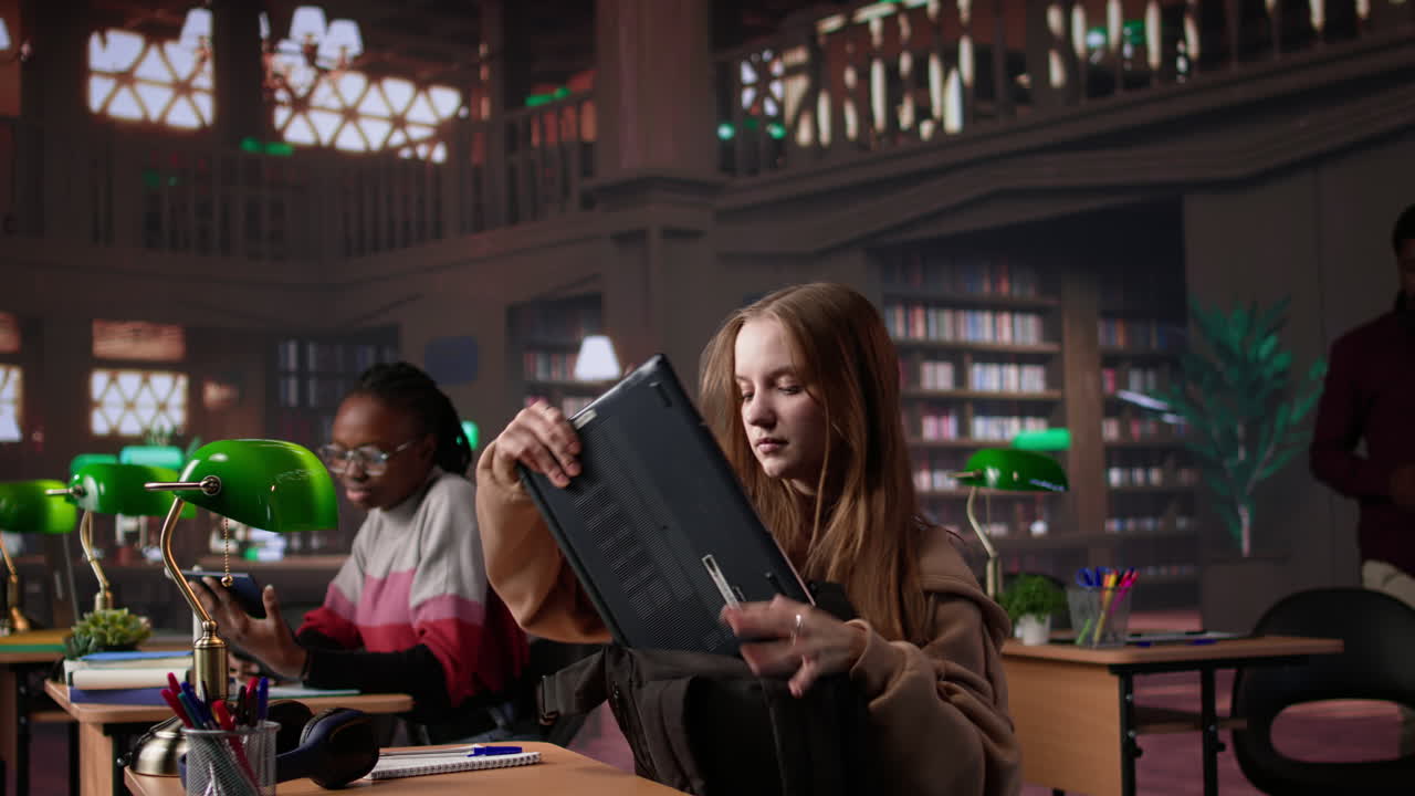 Vertical video focused girl arriving at university library and opening textbook to write notes