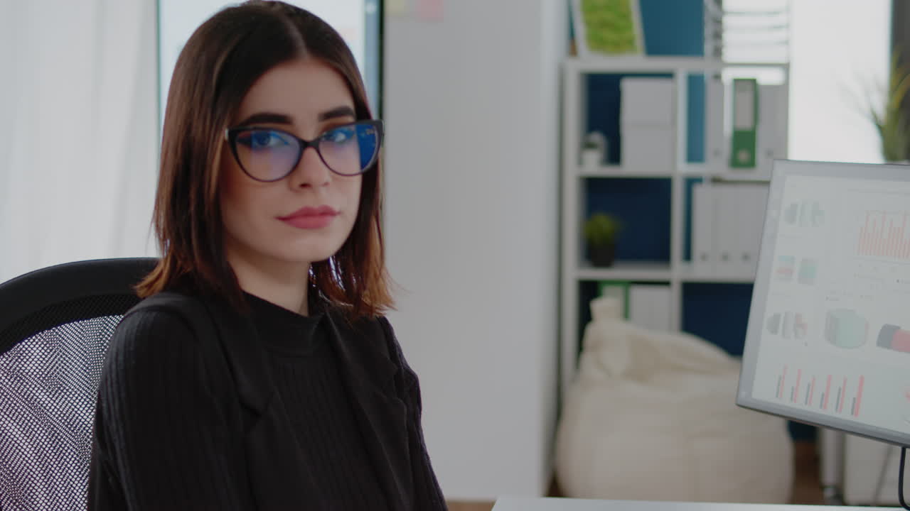 Portrait of woman with business job sitting at desk