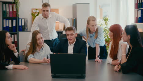 colleagues explaining on video call in meeting at office.