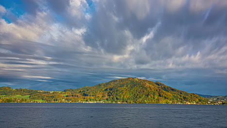 Lake-multicolor-tree-hill-time-lapse-moving-clouds-time-passing-nature-landscape