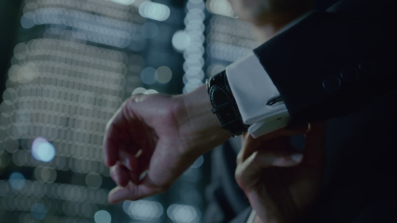 Close up shot of a businessman checking the time after leaving office with blurred background
