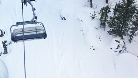 snowy mountain scene with snowboarder and ski lift