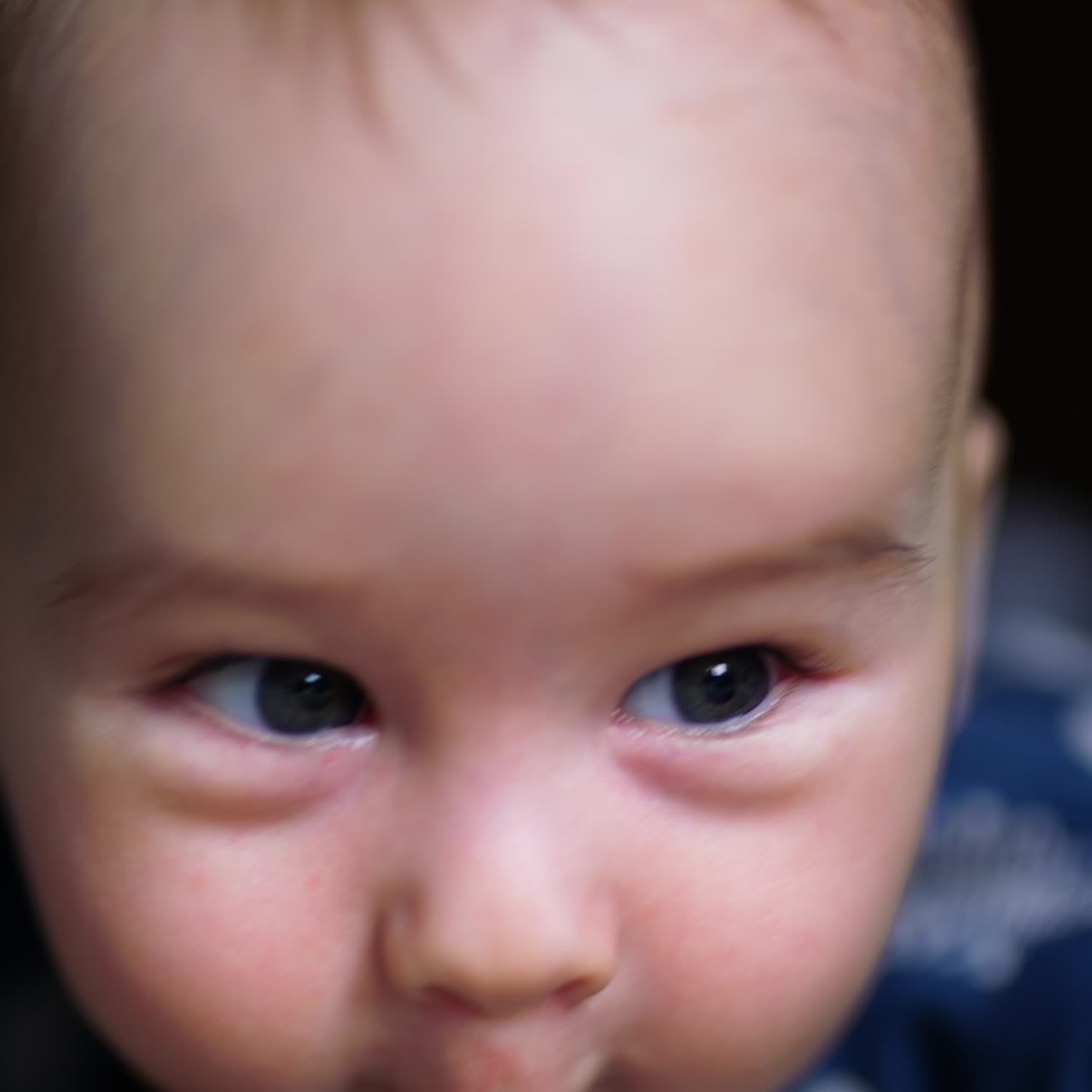 Beautiful cheerful face of a healthy Caucasian boy smiling to the camera. Close up. Blurred backdrop