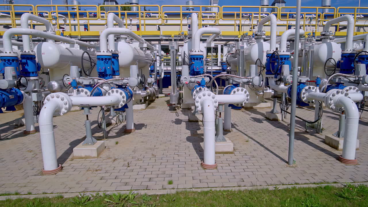 Front view of industrial gas pipelines and control valves at an energy facility in Riga. Riga, Latvia