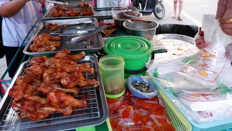 vendor packaging fried chicken at ayutthaya market