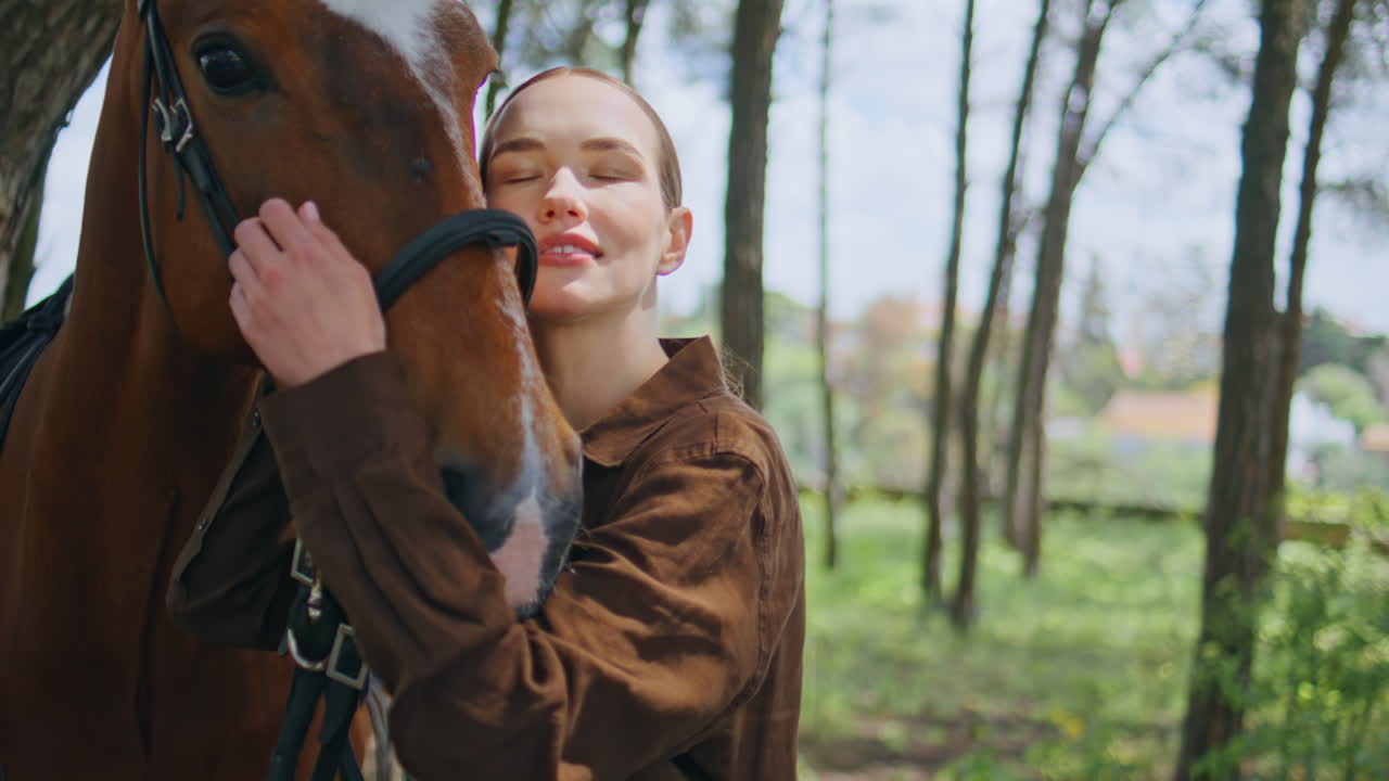 Relaxed woman posing horse at lush green nature closeup. Lady embracing animal