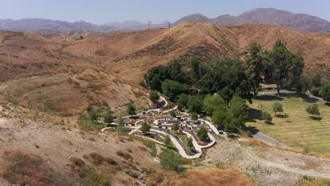 wide panning aerial shot of a relaxing nature garden at a mortuary in california