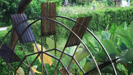 4k waterwheel spinning slowly close up with wooden paddles and metal frame